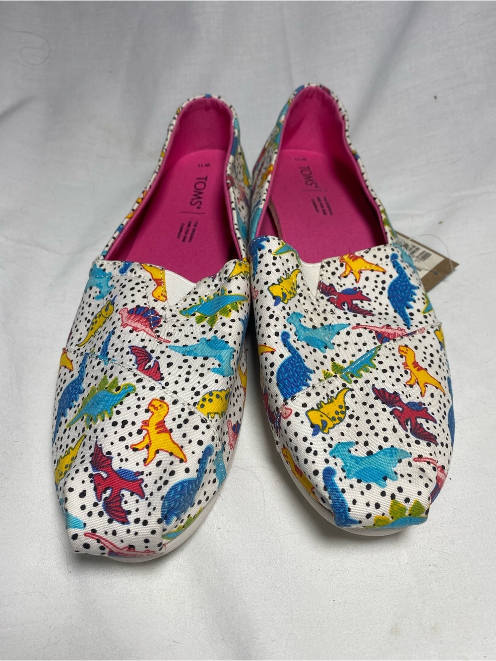TOMS women’s White Slip-Ons with Multicolor Dinosaur Print. US Sz 11